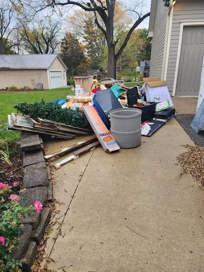 Dumpster being loaded with debris for 3 Yard Dumpster Rental in Atkinson